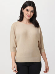 Woman wearing a beige sweater on a white background