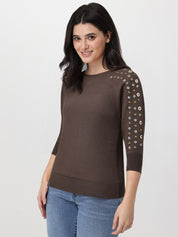 Woman wearing a brown sweater with mesh sleeves on a white background