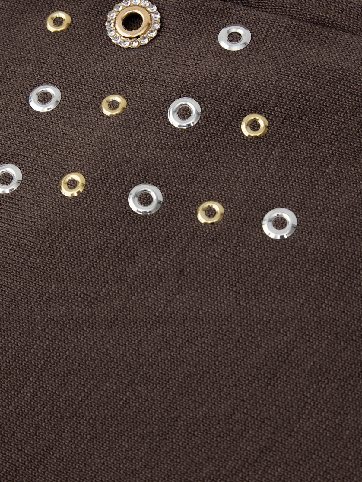 Close-up of decorative buttons on a brown fabric background