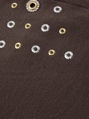 Close-up of decorative buttons on a brown fabric background