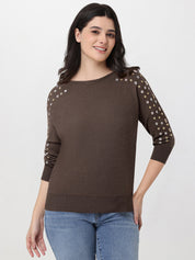 Woman wearing a brown sweater with decorative sleeves on a white background