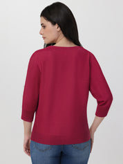 Woman wearing a red sweater and blue jeans on a white background