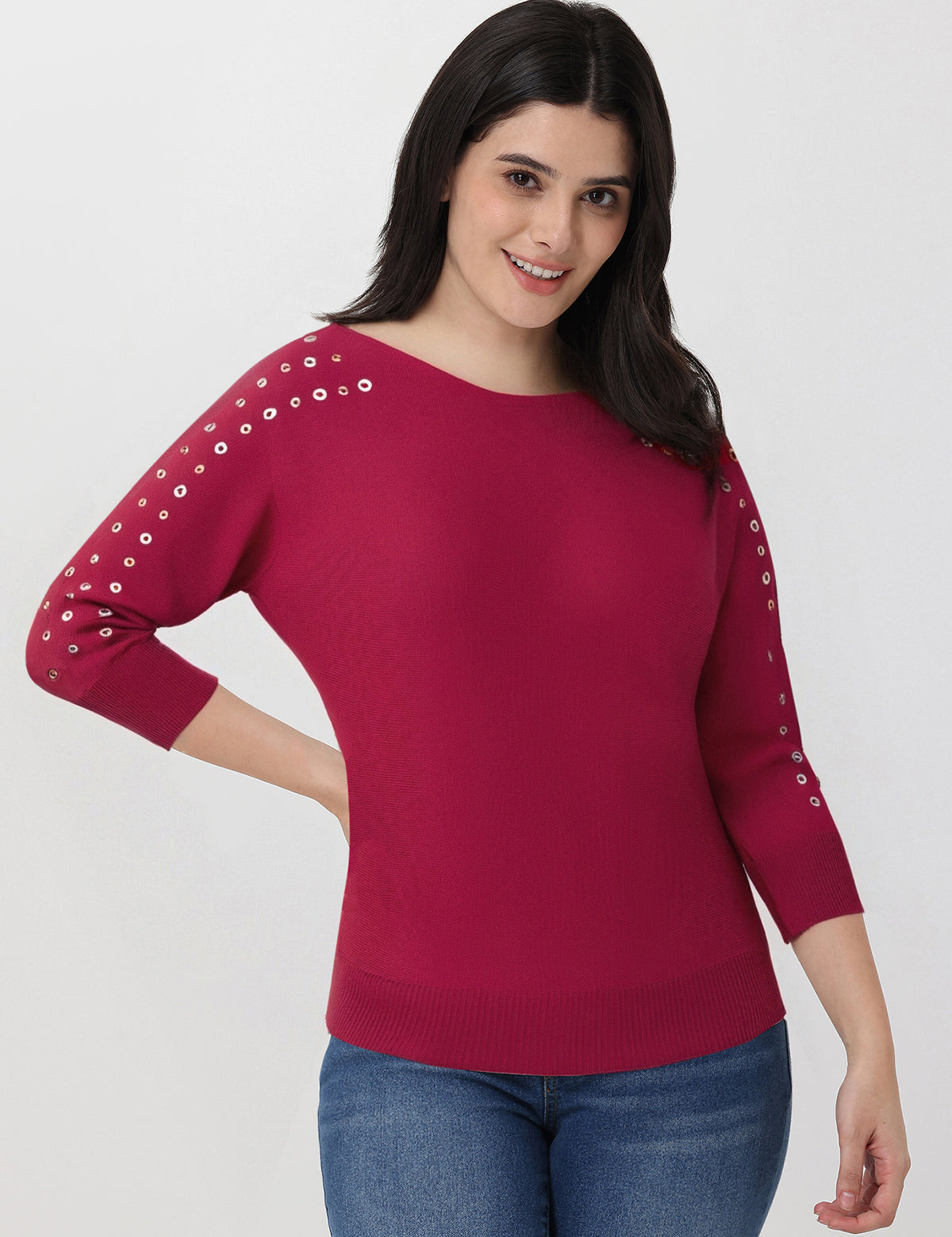 Woman wearing a red sweater with grommet sleeves on a white background