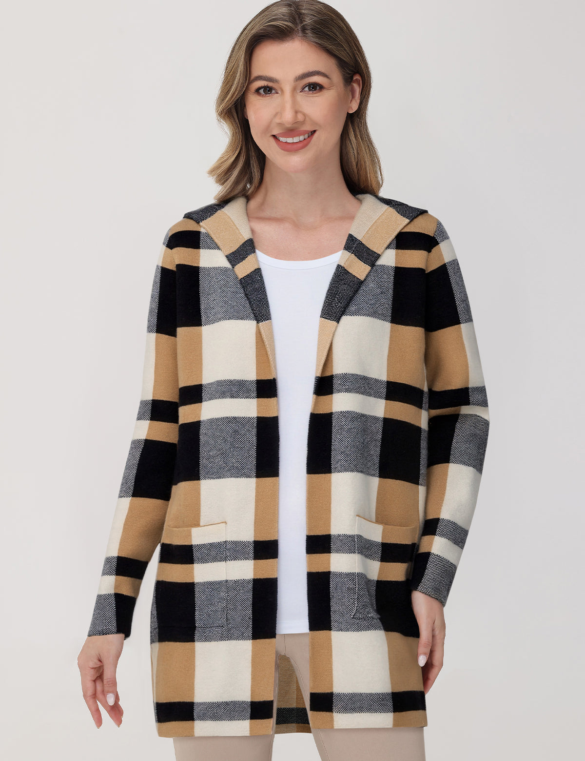 Woman wearing a checkered cardigan on a white background