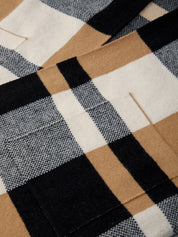 Close-up of a checkered fabric with brown, black, and white patterns.