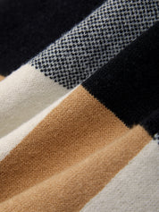 Close-up of fabric with black, white, brown, and beige stripes.