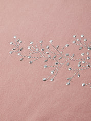 Rhinestone embroidery on a pink fabric background