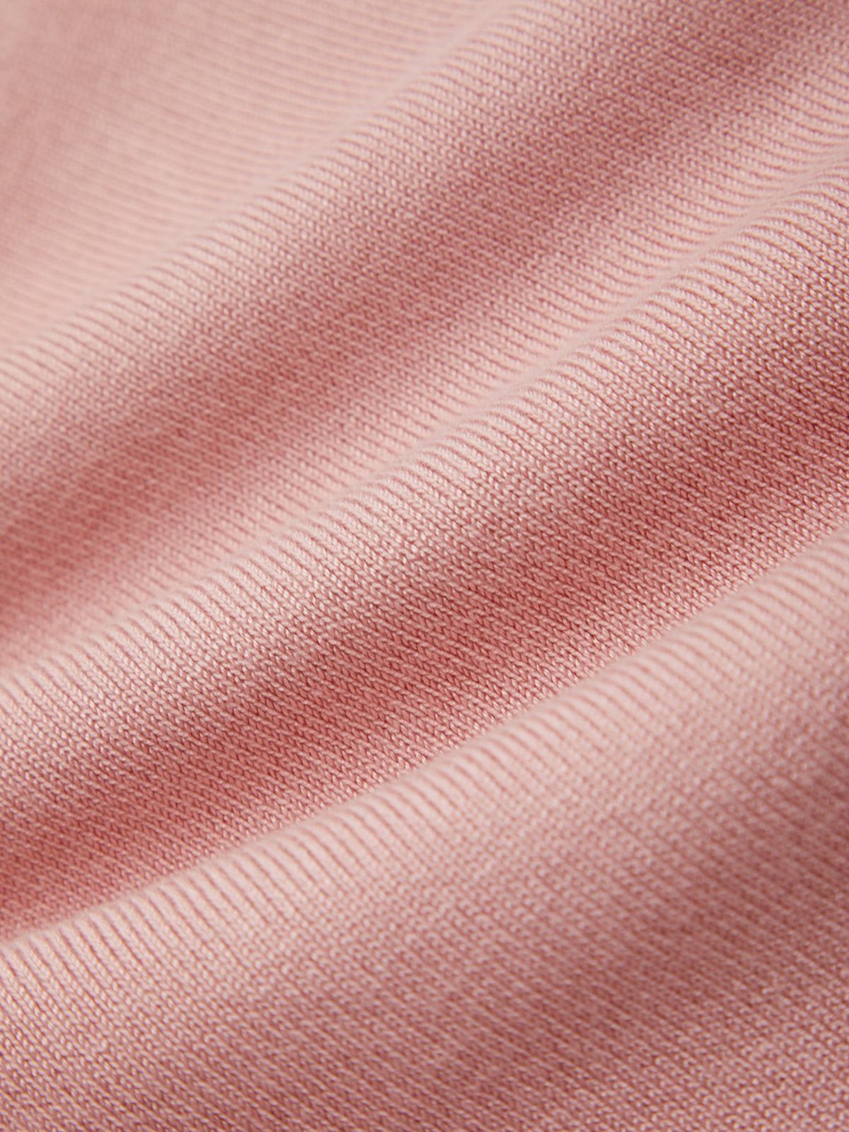 Close-up of pink fabric with a ribbed texture