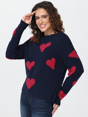 Woman wearing a navy sweater with red heart patterns on a white background