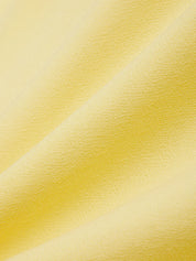 Close-up of yellow fabric with a subtle pattern