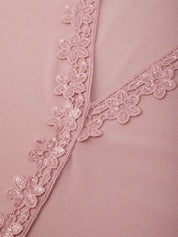 Close-up of a pink fabric with floral lace trim