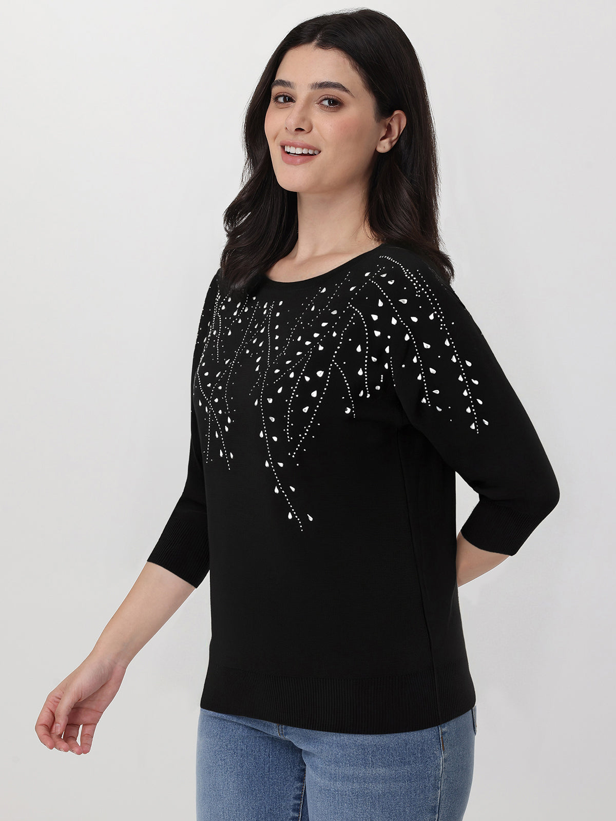 Woman wearing a black top with decorative sleeves on a white background