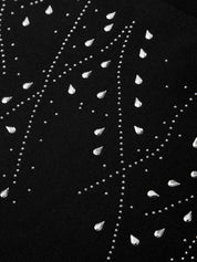 Close-up of a black fabric with white bead patterns