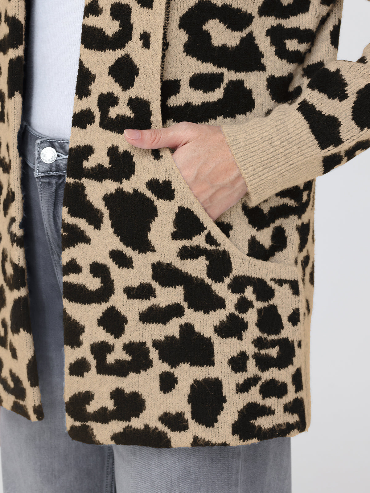 Leopard print cardigan worn by a person, with a focus on the pattern and texture.