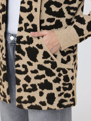 Leopard print cardigan worn by a person, with a focus on the pattern and texture.