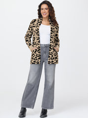 Woman wearing a leopard print cardigan, white top, and gray jeans on a white background