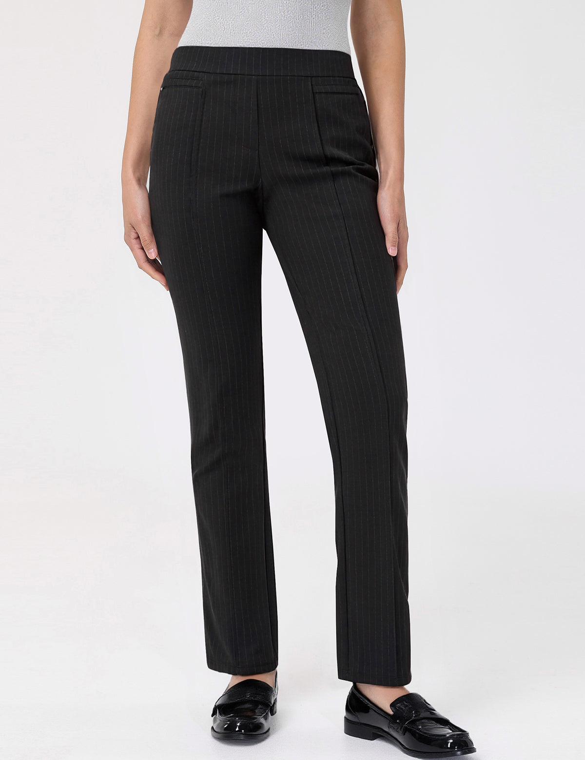Black pinstripe pants worn by a person on a white background