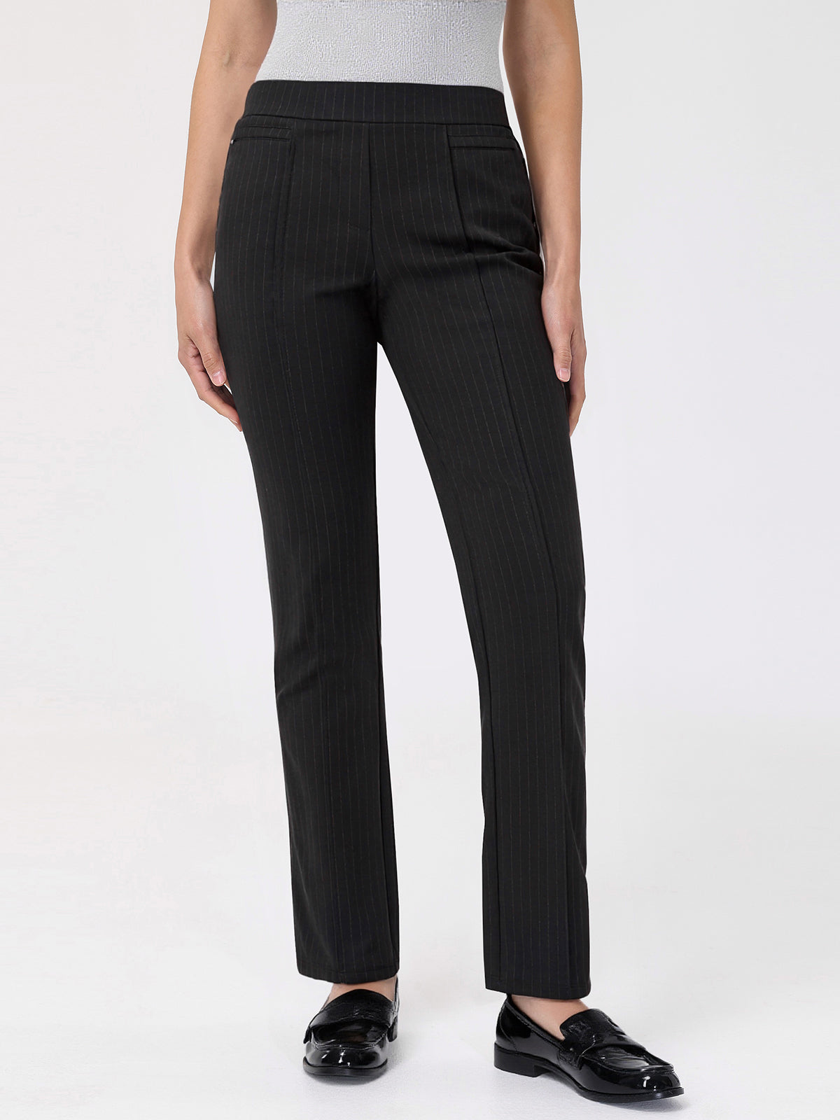 Black pinstripe pants worn by a person on a white background