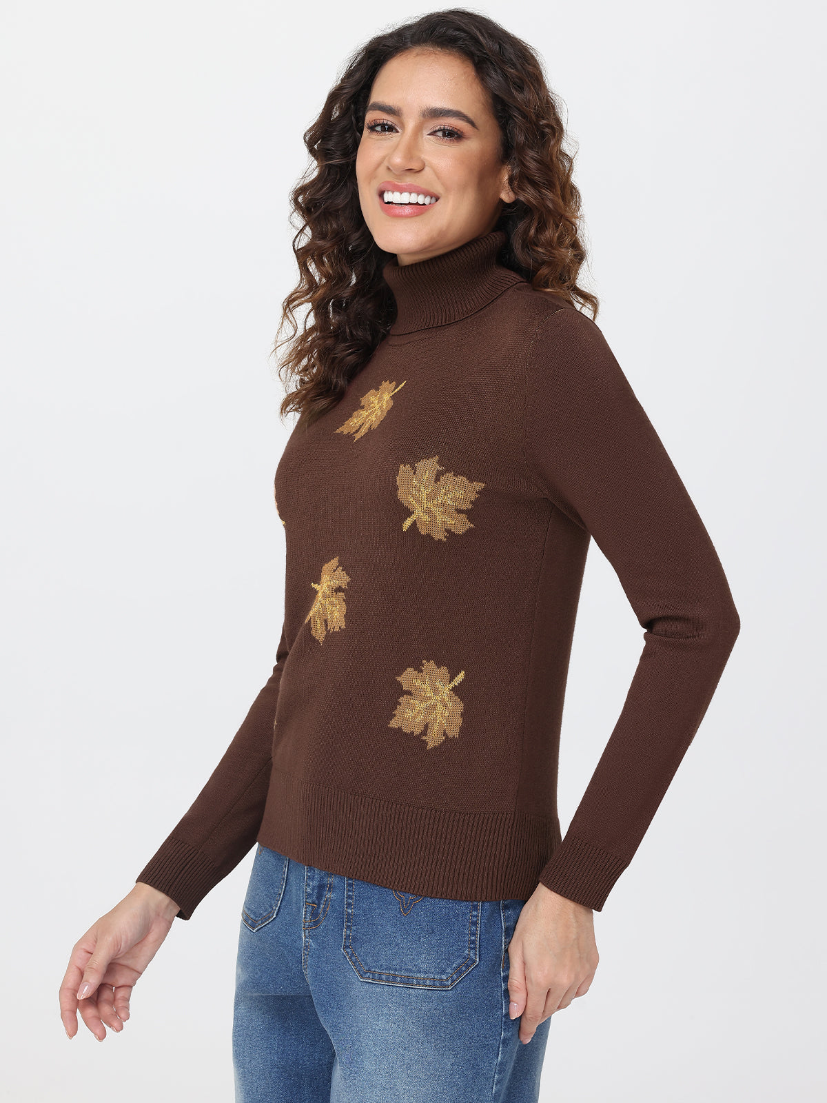 Woman wearing a brown sweater with leaf patterns on a white background