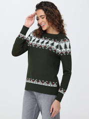 Woman wearing a green sweater with a pattern, standing against a white background