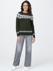 Woman wearing a green sweater with a pattern and gray pants on a white background