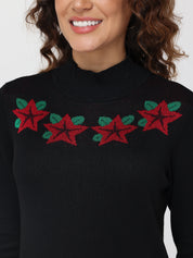 Black sweater with red and green star pattern worn by a person