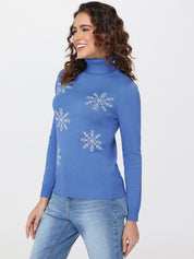 Woman wearing a blue sweater with snowflake patterns on a white background