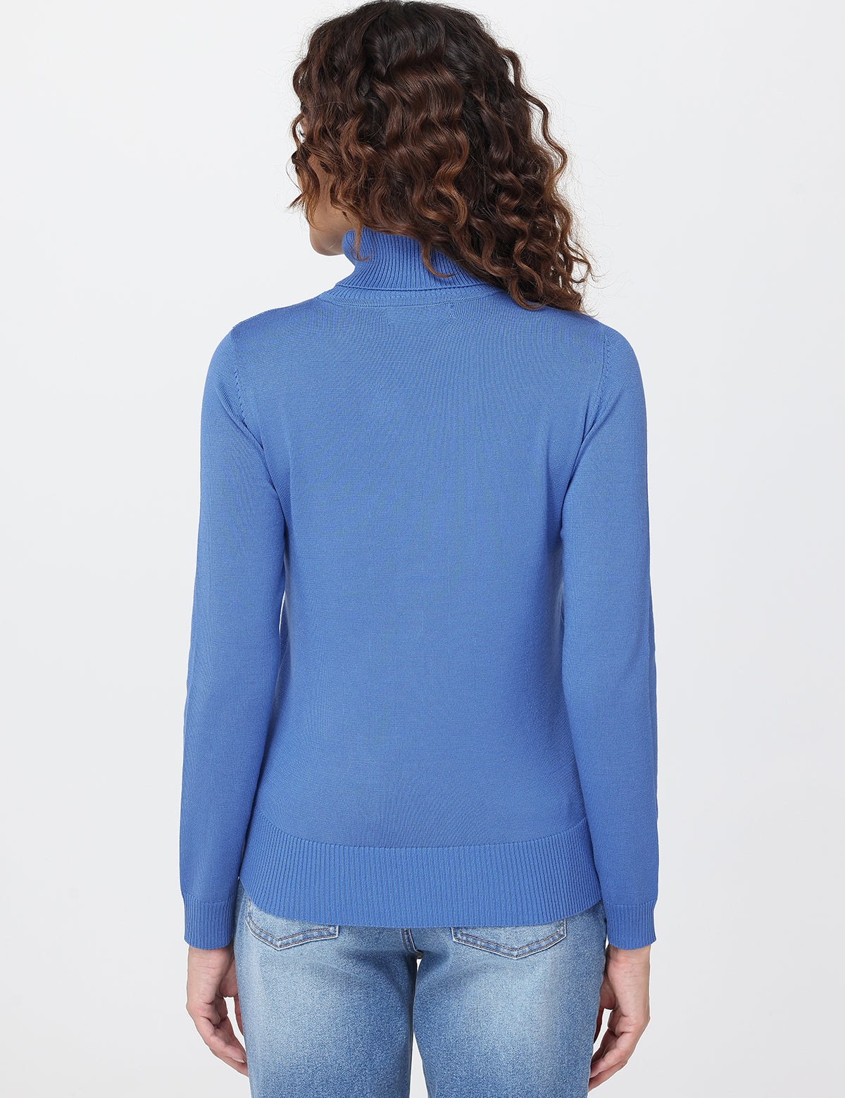Person wearing a blue turtleneck sweater on a white background