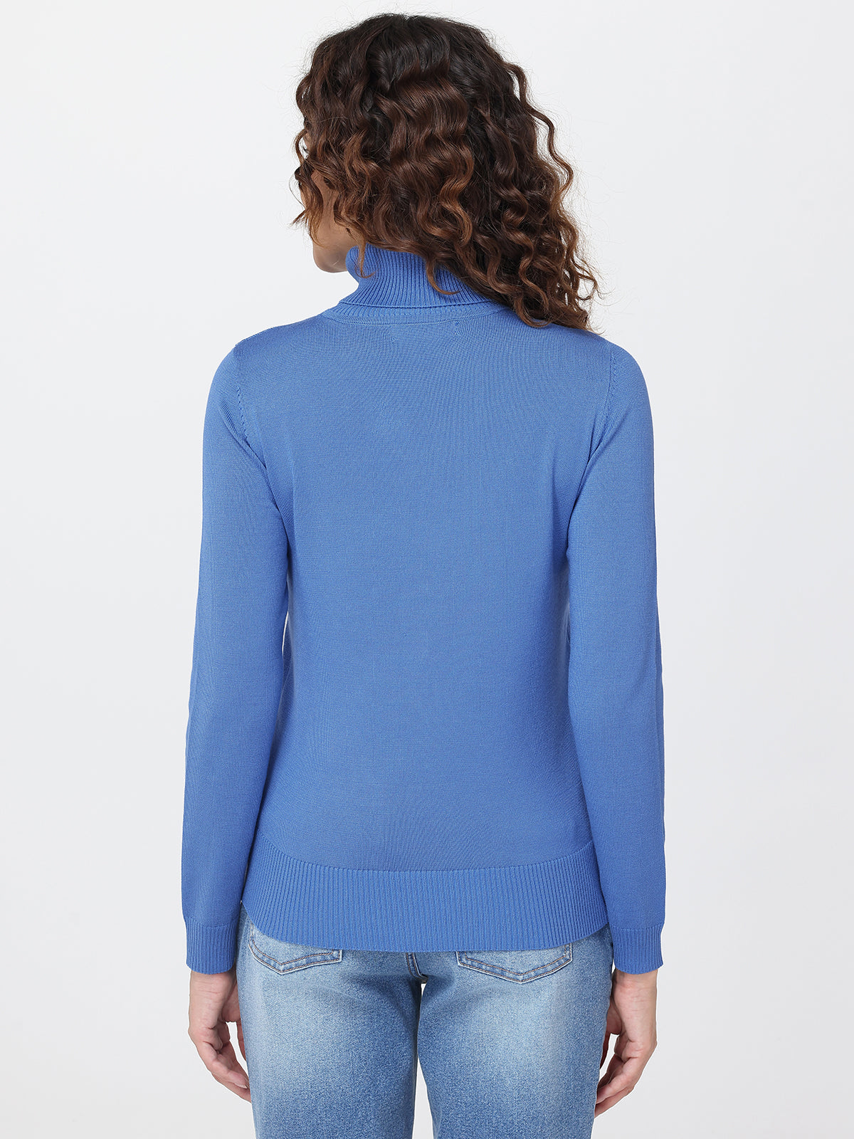Person wearing a blue turtleneck sweater on a white background