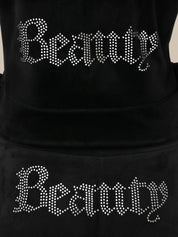 Black hoodie with 'Beauty' text in rhinestone letters on a plain background