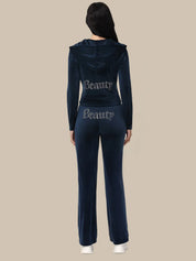 Person wearing a navy tracksuit with 'Beauty' text on a beige background