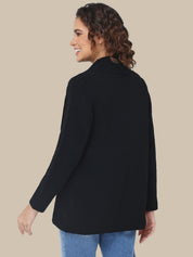 Woman wearing a black jacket on a beige background