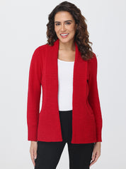Woman wearing a red cardigan over a white shirt on a plain background