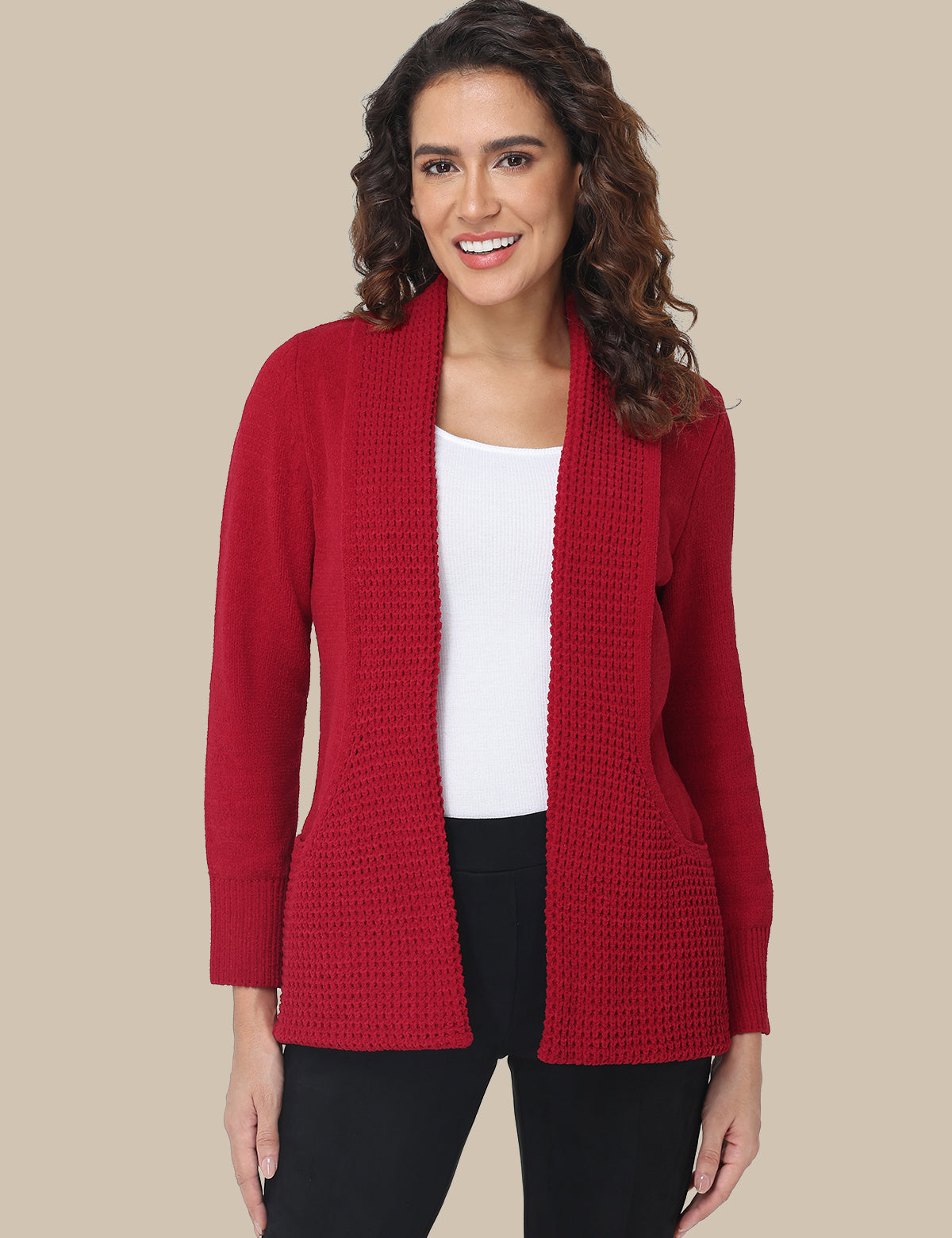 Woman wearing a red cardigan over a white shirt on a beige background