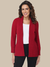 Woman wearing a red cardigan over a white shirt on a beige background