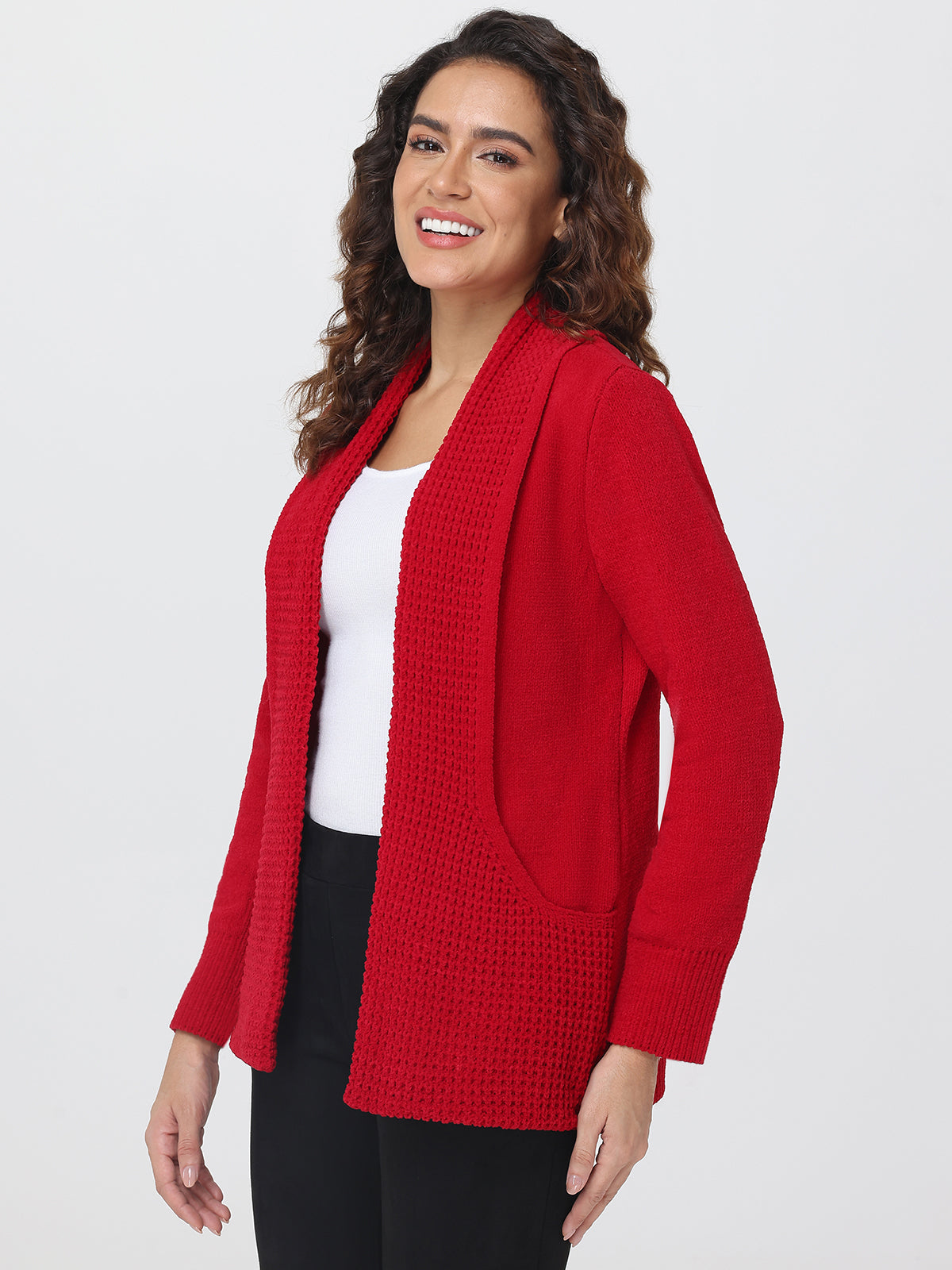 Woman wearing a red cardigan over a white top on a white background