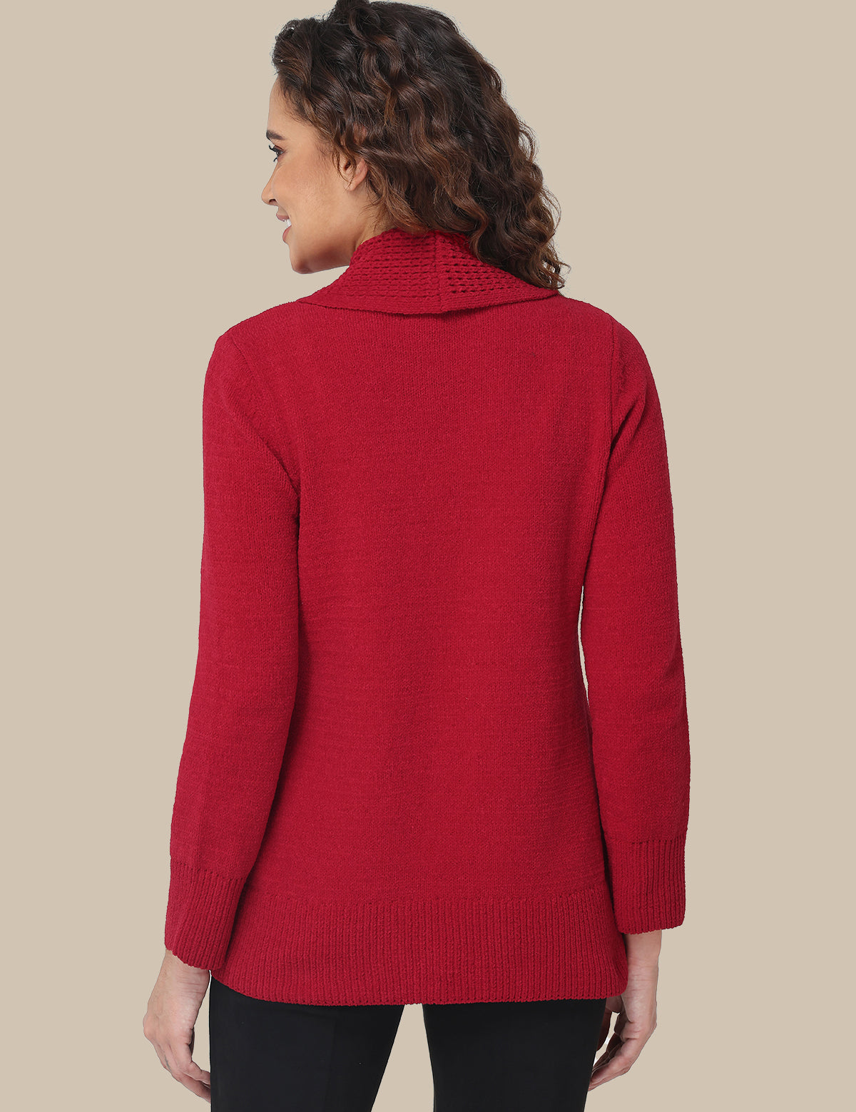 Woman wearing a red sweater against a beige background