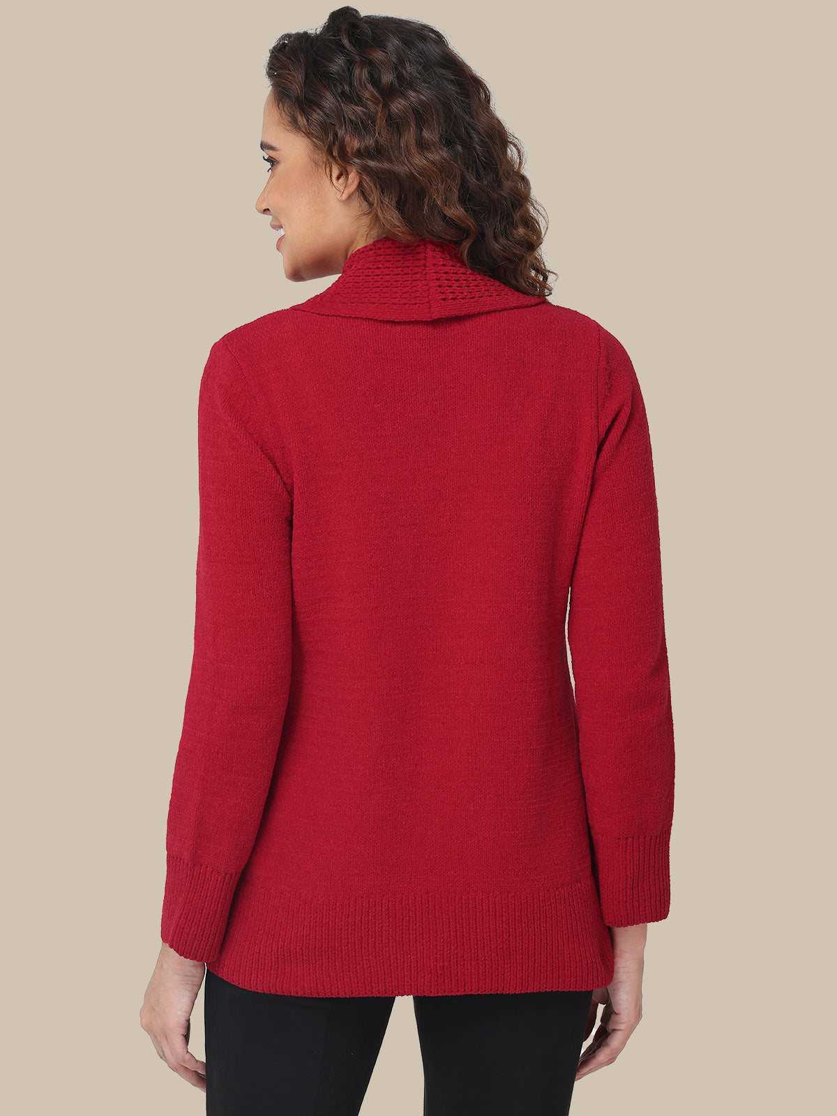 Woman wearing a red sweater against a beige background