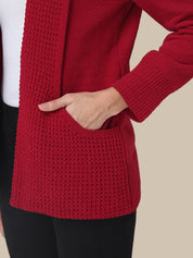 Red knitted cardigan worn by a person on a beige background