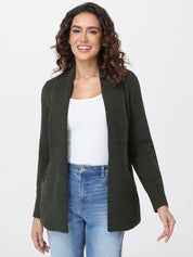 Woman wearing a green cardigan over a white top and blue jeans on a white background
