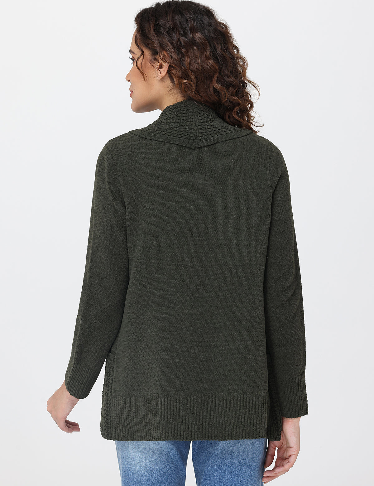 Woman wearing a green sweater against a white background
