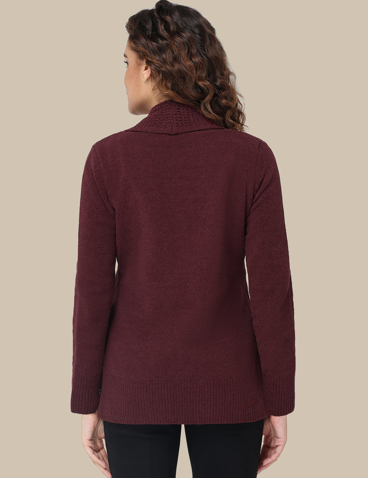 Woman wearing a burgundy sweater against a beige background