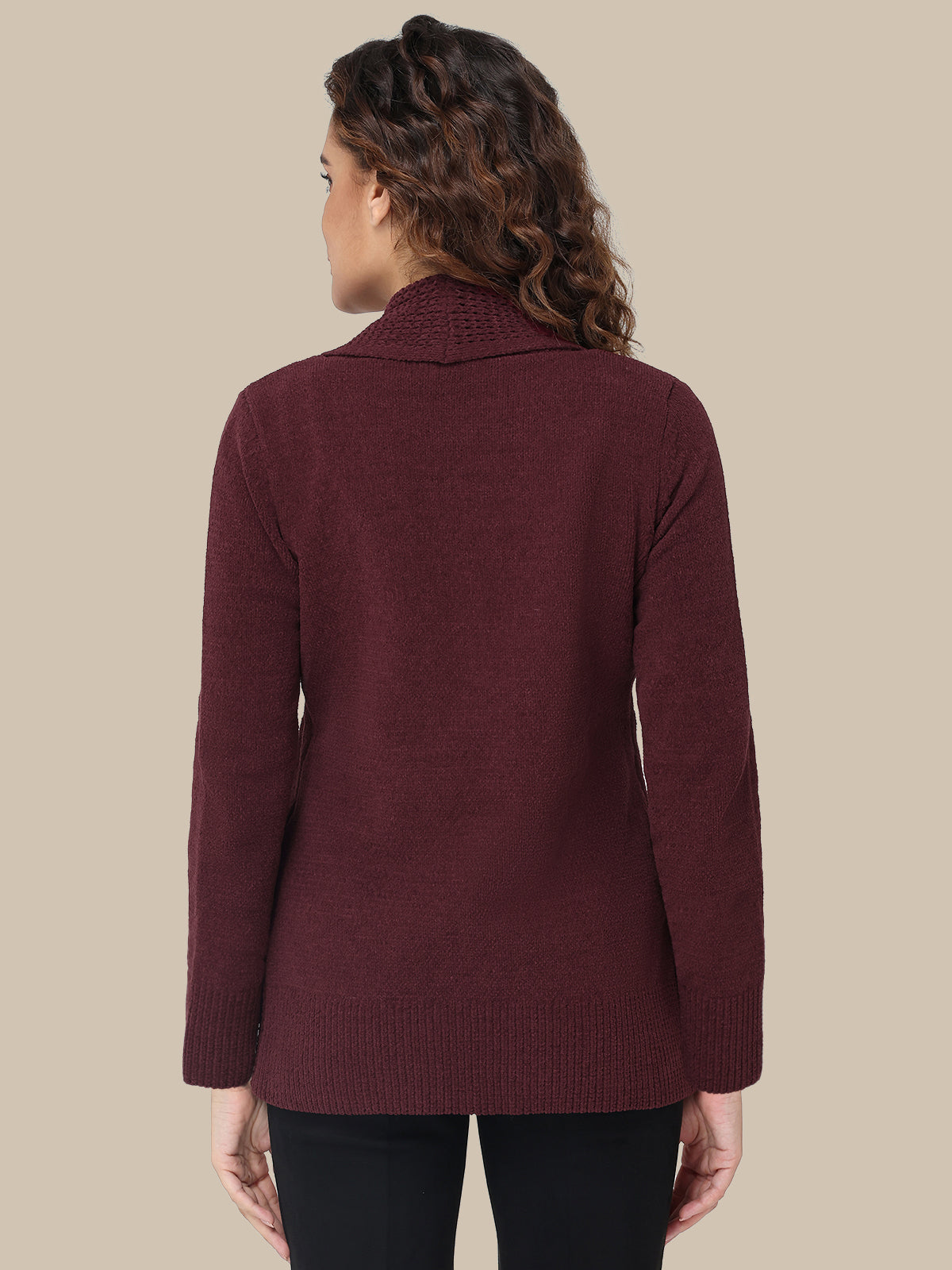 Woman wearing a burgundy sweater against a beige background