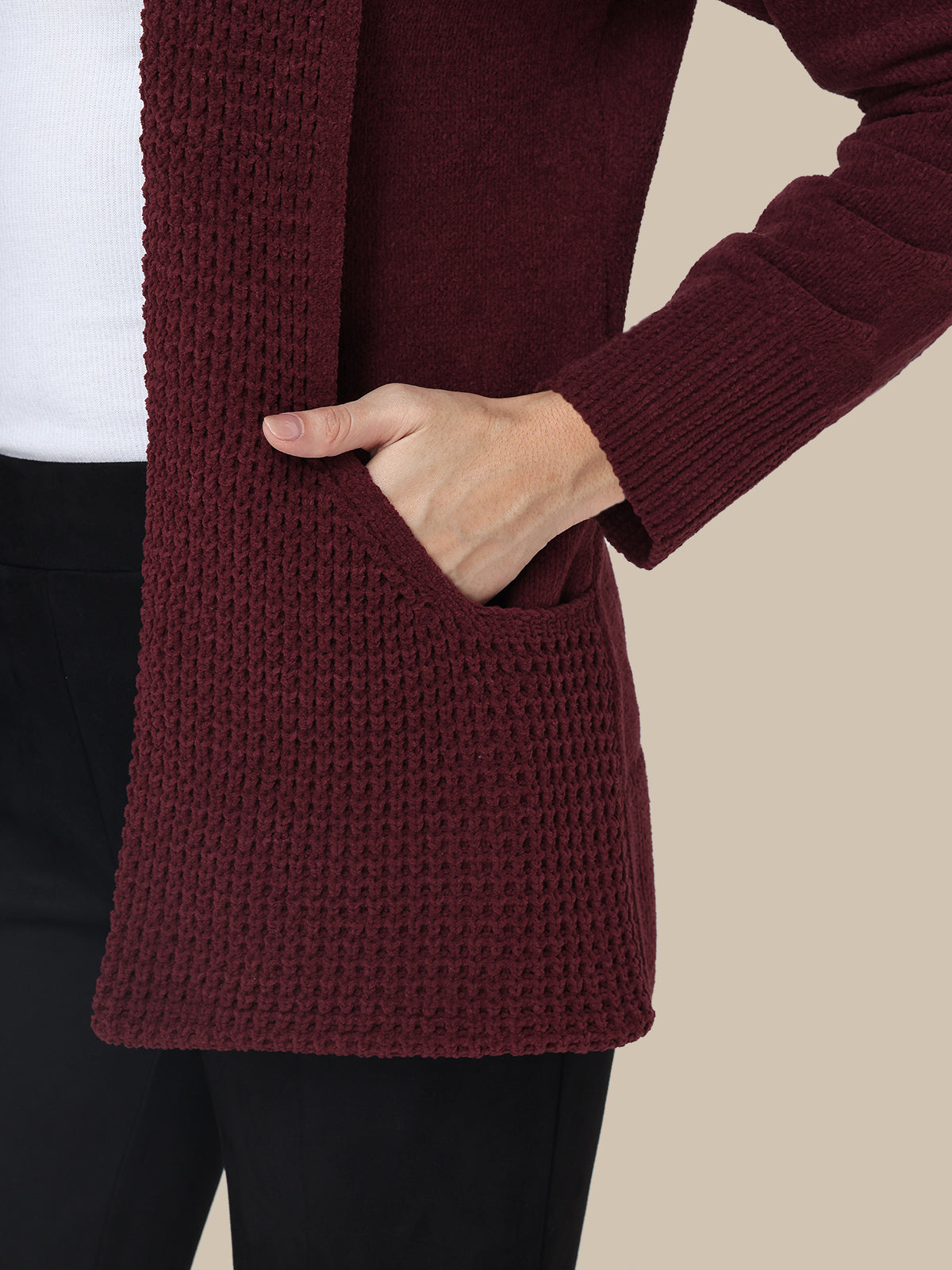 Maroon cardigan worn by a person with a white background