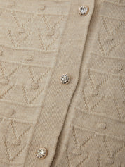 Close-up of a beige textured fabric with button details