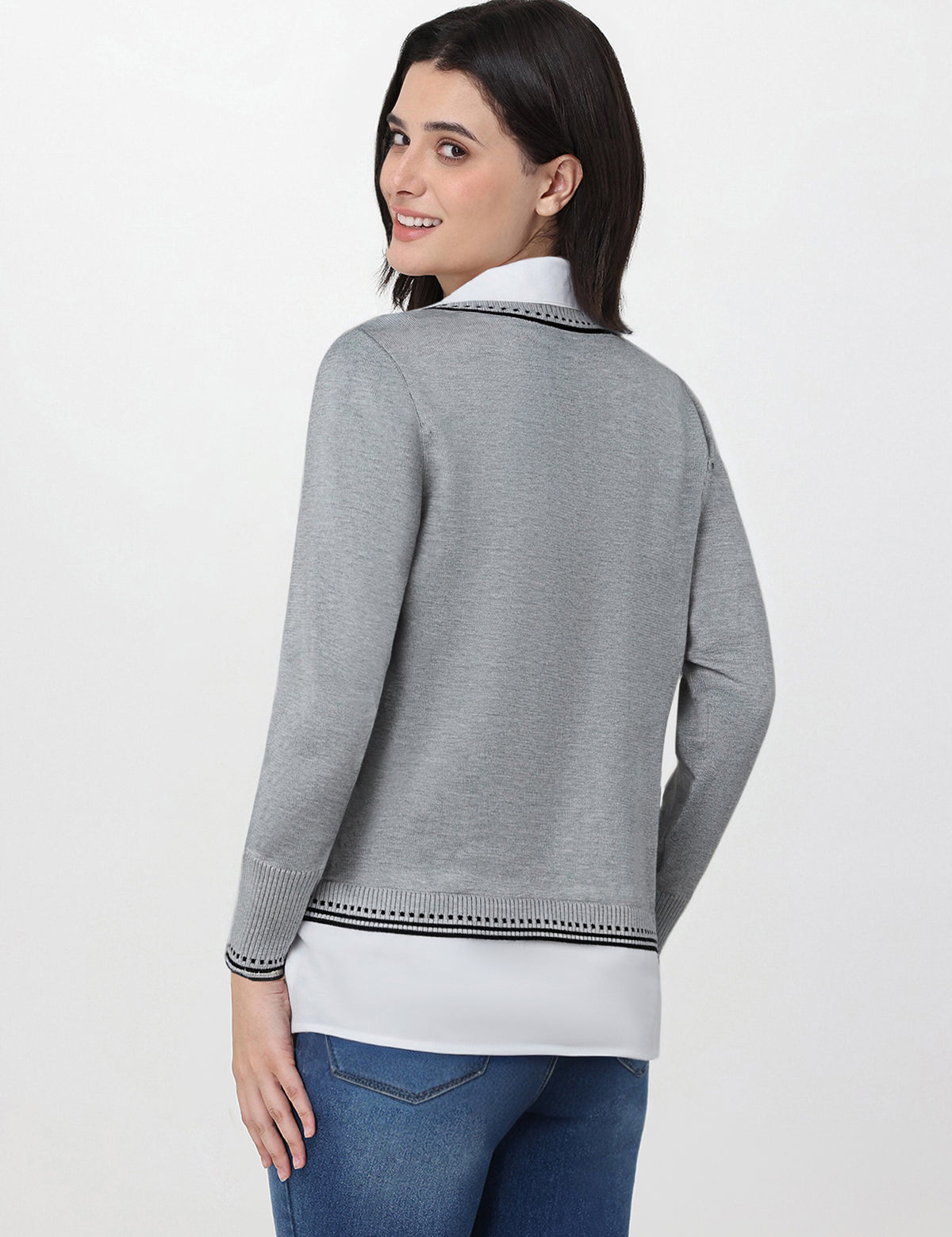 Woman wearing a gray sweater with a white collar on a white background