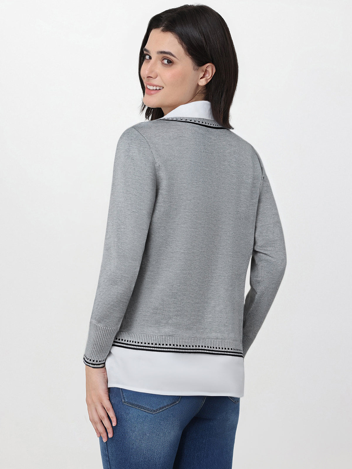 Woman wearing a gray sweater with a white collar on a white background