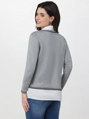 Woman wearing a gray sweater with a white collar on a white background