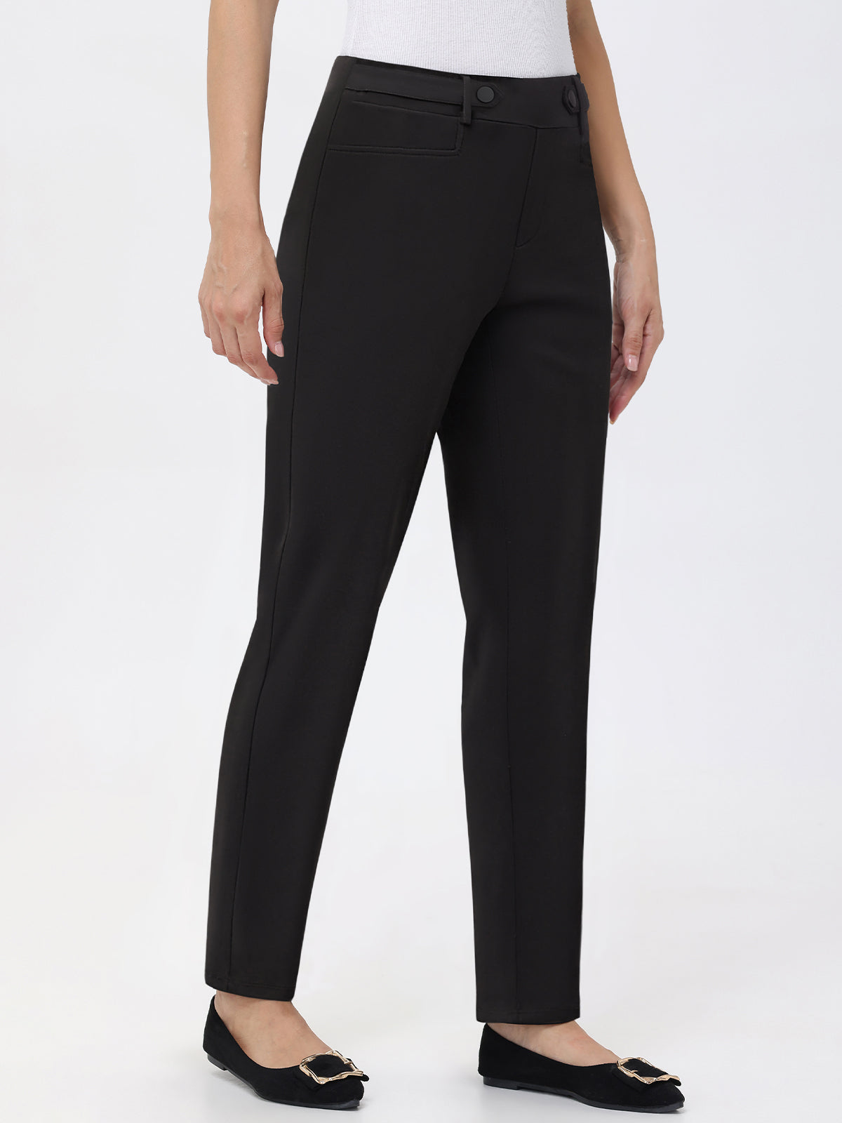 Black pants worn by a person on a white background