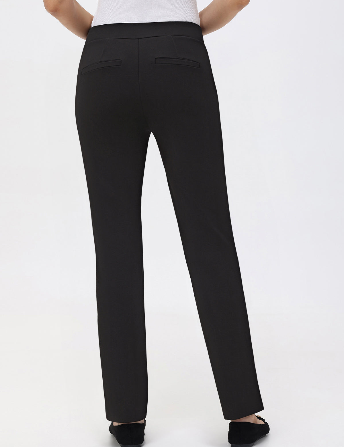 Black pants worn by a person on a white background